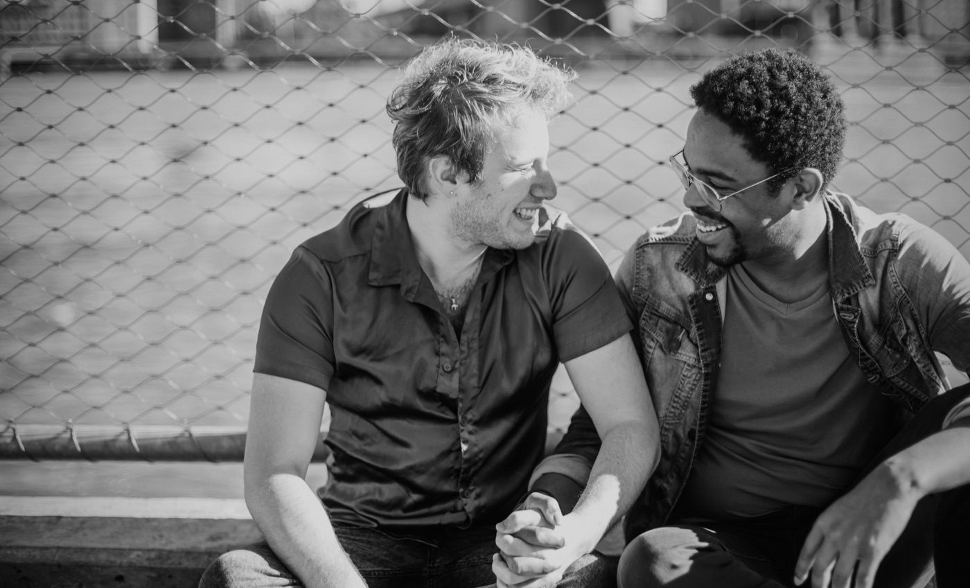 Two men sharing a laugh on an outdoor bench